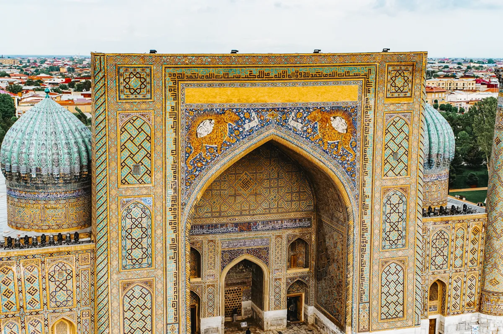 Sher-Dor Madrasa at Registan in Samarkand with tiger mosaics above the entrance.