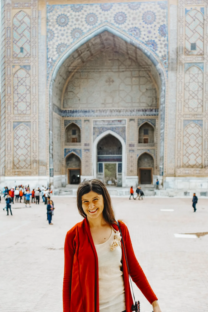Woman standing in front of Ulugh Beg Madrasa at Registan Square in Samarkand